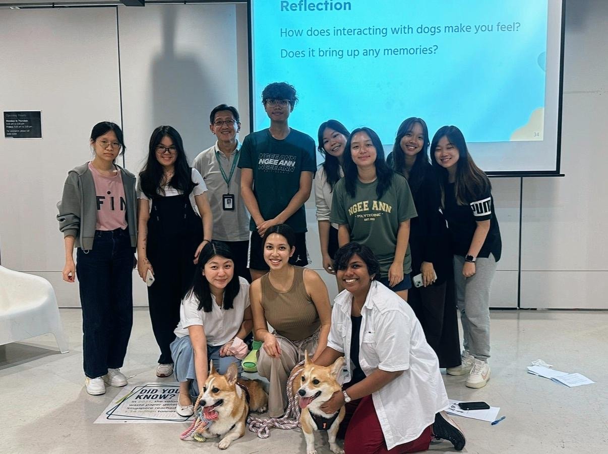 The Little Marvels team with therapy dogs and students at a Ngee Ann Polytechnic workshop